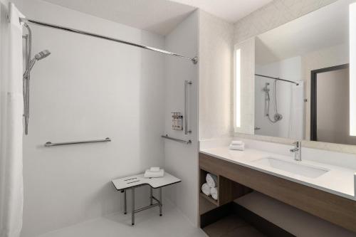 a white bathroom with a sink and a shower at Holiday Inn Express & Suites Buford NE - Lake Lanier by IHG in Buford