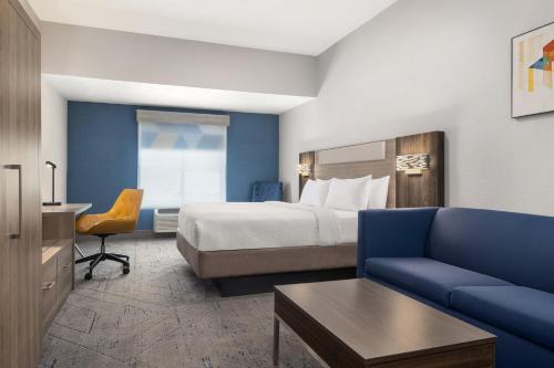 a hotel room with a bed and a couch at Holiday Inn Express & Suites Buford NE - Lake Lanier by IHG in Buford