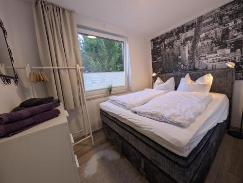 a bedroom with a large bed with a window at H-Lodges - TOP City-Appartments in Essen in Essen