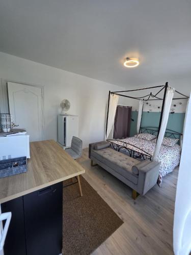 a bedroom with a bed with a canopy at Les Perriers in Chambray-lès-Tours