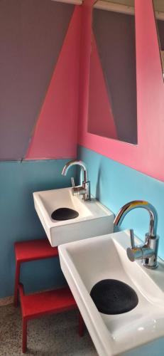 a bathroom with two sinks and a red stool at Train Lodge Amsterdam in Amsterdam