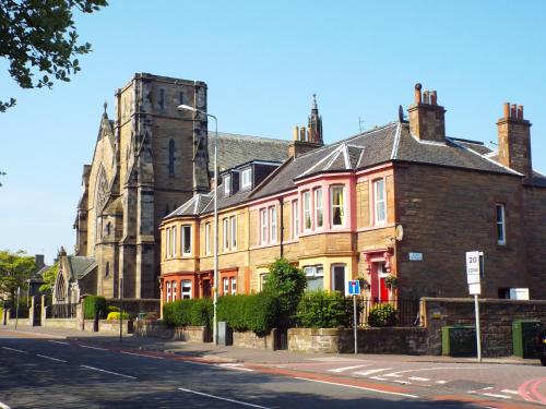 a large brick building on a street with a church at Badjao B&B in Edinburgh