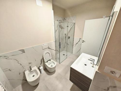a bathroom with a toilet and a sink and a shower at MS Sea Port Rooms in Ancona
