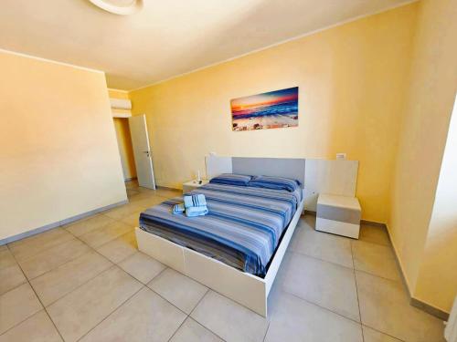 a bedroom with a bed and a painting on the wall at MS Sea Port Rooms in Ancona