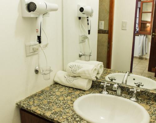 a bathroom with a sink and a hair dryer at Inti Masi in Salta