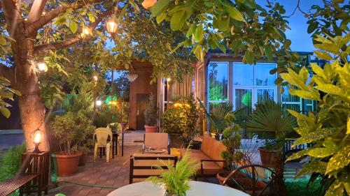 a garden with tables and chairs and a tree at Green Land in Tbilisi City