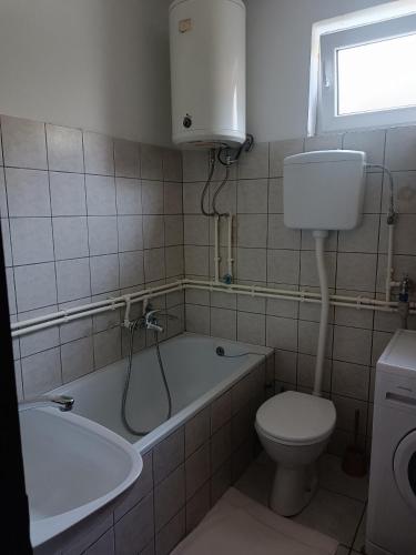 a bathroom with a tub and a toilet and a sink at Vikendica Miki 2 in Bratunac