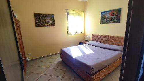 a bedroom with a bed and a window at Basilicata Host To Host - BORGO SAN BASILIO 2 in Marina di Pisticci