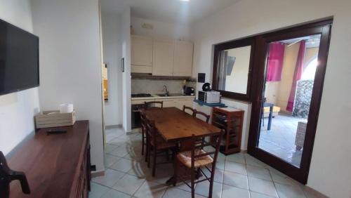 a kitchen and dining room with a table and chairs at Basilicata Host To Host - BORGO SAN BASILIO 2 in Marina di Pisticci