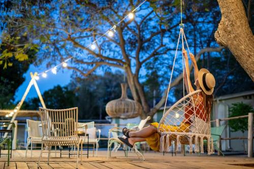 a person sitting on a swing in a chair at Eretz Zeelim in Ẕeʼelim