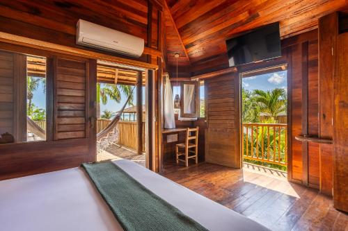 a bedroom with a bed and a view of the ocean at Hurricane Jeri in Jericoacoara