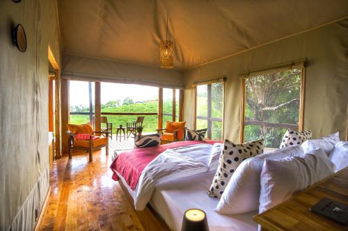 a bedroom with a bed in a tent at Rhotia Valley Tented camp in Karatu