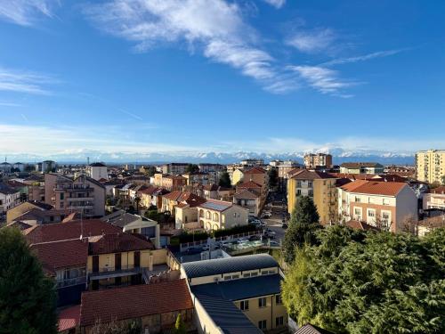 a city with buildings and mountains in the background at SNG - Paggi 78 in Vercelli