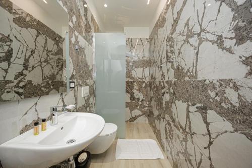 a bathroom with a sink and a toilet at Laid Hotel in Vlorë