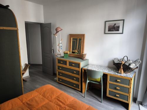 a bedroom with a dresser and a desk with a mirror at Historic Downtown II in Vila Real