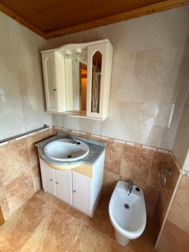a bathroom with a sink and a toilet at Casa Gallopin in Foz