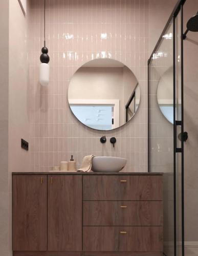a bathroom with a sink and a mirror at GW Apart in Gorzów Wielkopolski