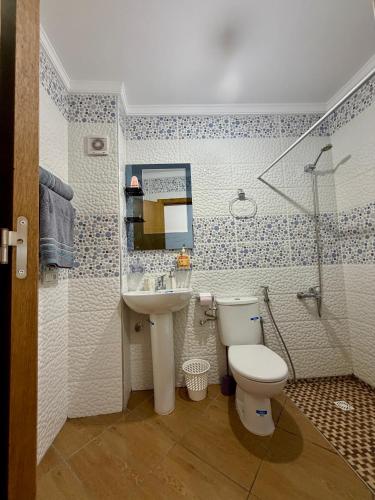 a bathroom with a toilet and a sink and a shower at Paraiso Costero Azla Tetouan in Azla