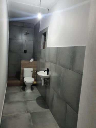 a bathroom with a toilet and a sink at Cooperville 1 in Potchefstroom