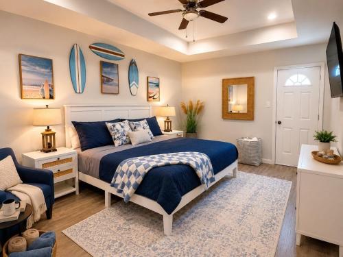 a bedroom with a bed and a ceiling fan at Beachfront Luxe, Ocean Views, Hot tub, Firepit, Sleeps 14 in Bolivar Peninsula