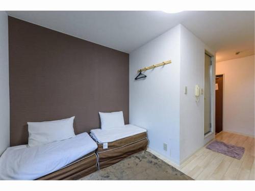 two beds sitting next to each other in a room at Sora / Vacation STAY 1124 in Sakai