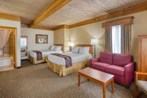 a hotel room with two beds and a couch at Best Western Plains Motel in Wall