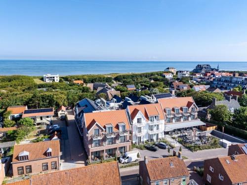an aerial view of a small town with houses and the ocean at Hotel The Dunes in Domburg