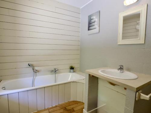 a bathroom with a tub and a sink at Le Moulin de Rendeux in Rendeux