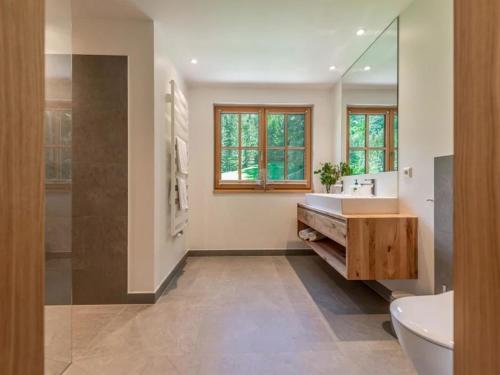 a bathroom with a tub and a sink and a mirror at Chalet Jona in Sonnberg