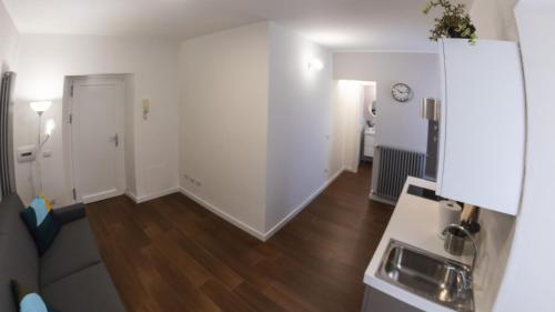 a living room with white walls and wooden floors at Casa Frino in Ghiffa