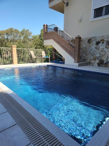 a swimming pool with a staircase in a house at Mijas Villa Doña Pilar Pool & Jacuzzi in Mijas