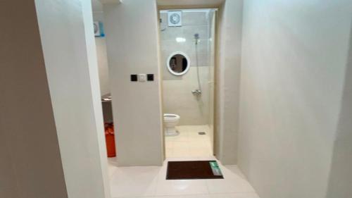 a white bathroom with a toilet and a mirror at شاليه الكوثر in Al Baha