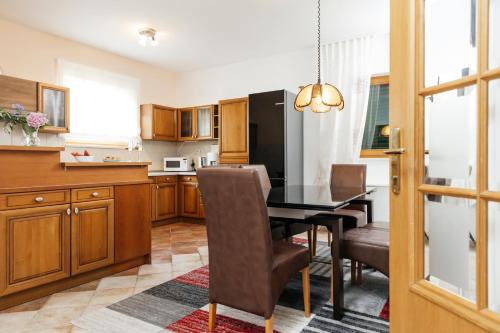 a kitchen and dining room with a table and chairs at Villa Žnjan in Split