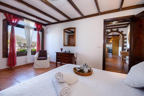 a bedroom with a bed and a desk and a window at Clara Suite 2 - Macaronesiahomes in Masdache