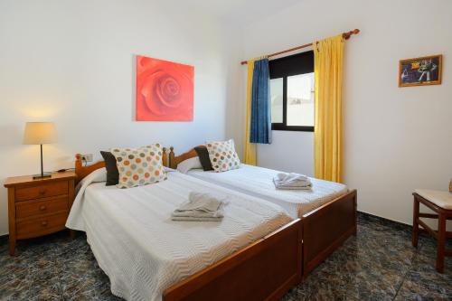 a bedroom with a bed and a window at Caleta Blue House - Macaronesiahome in Caleta de Caballo