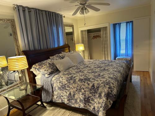 a bedroom with a bed and a glass table at Pigeon's Roost on Rushmore in Rapid City