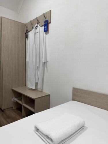 a white room with a bed and a mirror at Hotel BK in Kyiv