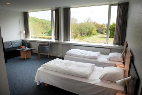 Postel nebo postele na pokoji v ubytování Vingsted Hotel & Konferencecenter