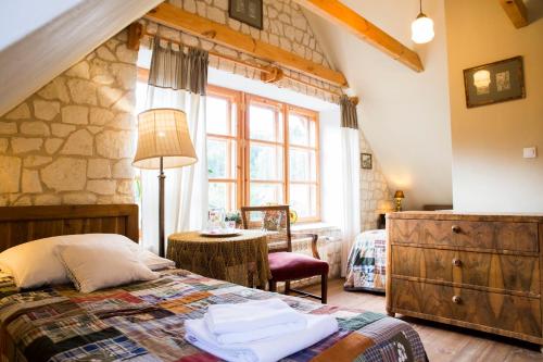 a bedroom with a bed and a large window at Siódmy Las in Zawada