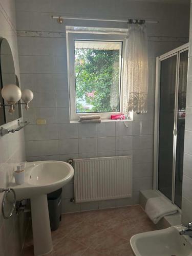 a bathroom with a sink and a window at Willa Aqua -parking included in the price in Świnoujście