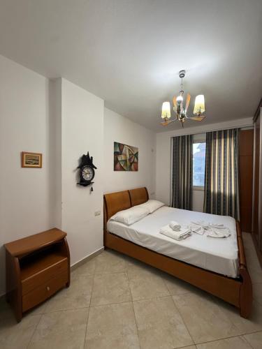 a bedroom with a bed and a clock on the wall at Tirana Panorama in Tirana