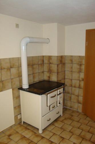 a kitchen with a pipe on the wall at Haus am Treffenbach in Waldmünchen