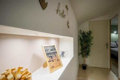 a white room with a picture on a wall at Le Cocon Vouté, air-conditioned in Saint-Laurent-des-Arbres