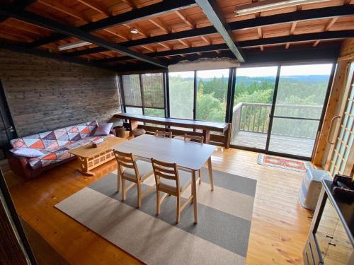 a living room with a table and chairs and a couch at DeepSpot - Vacation STAY 19274v in Minamioguni