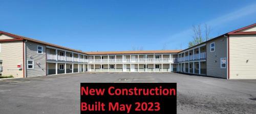 a new construction built may sign in a parking lot at Driftwood Motel in Niagara Falls