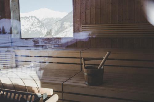 a sauna with a bucket and a stick in it at Arabella Retreat & Spa in Nauders