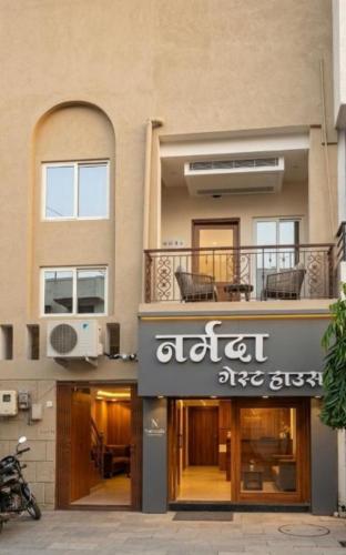 a building with a sign on the side of it at NG House in Indore