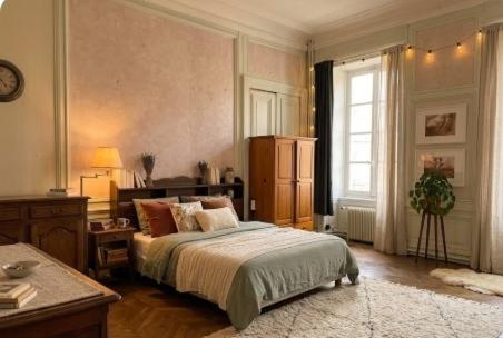 a bedroom with a large bed and a window at La Miséricorde-Deluxe room with kids room in Coutances