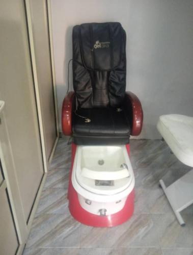 a toilet with a seat on top of it at Luxritel Hotel Abuja in Kajewole