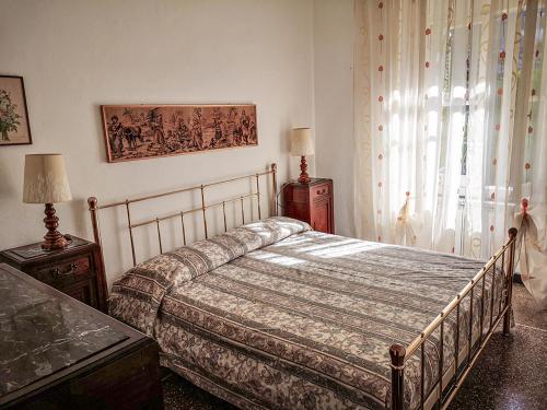 a bedroom with a bed and a window at B&B Da Beppe in Neirone